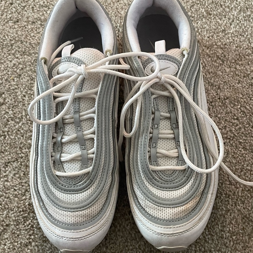 White Nike Air Max gym shoes.